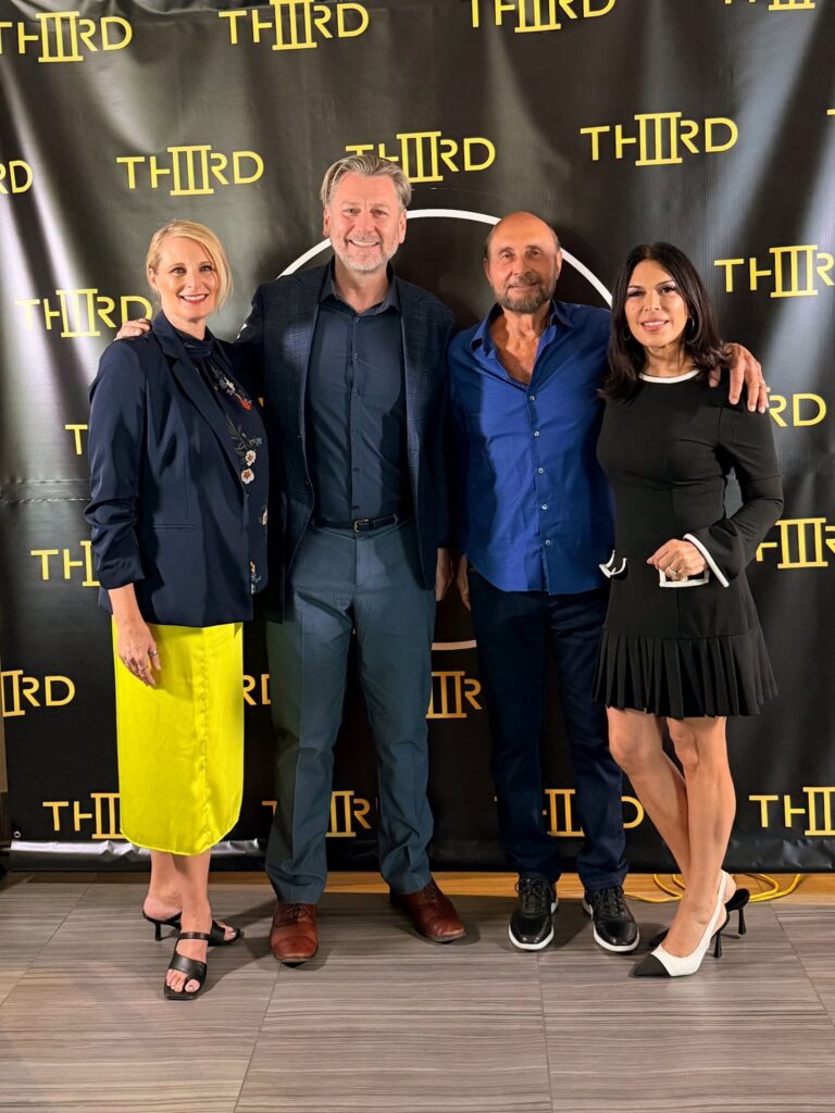 Ginger Land-van Buuren, Daz Weller, Ed Bernstein and Claudia Noriega-Bernstein in front of a THIRD Street backdrop at the Downtown Las Vegas arts incubator