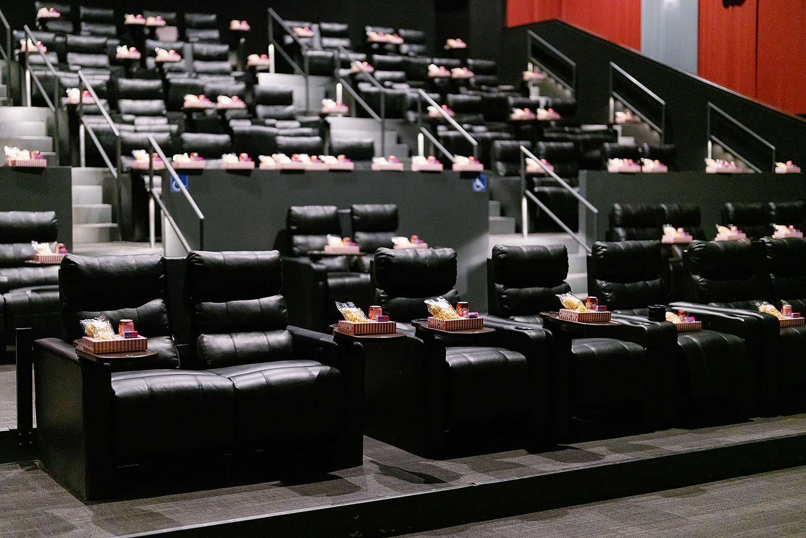 Luxury recliners with tray tables in a private movie theater