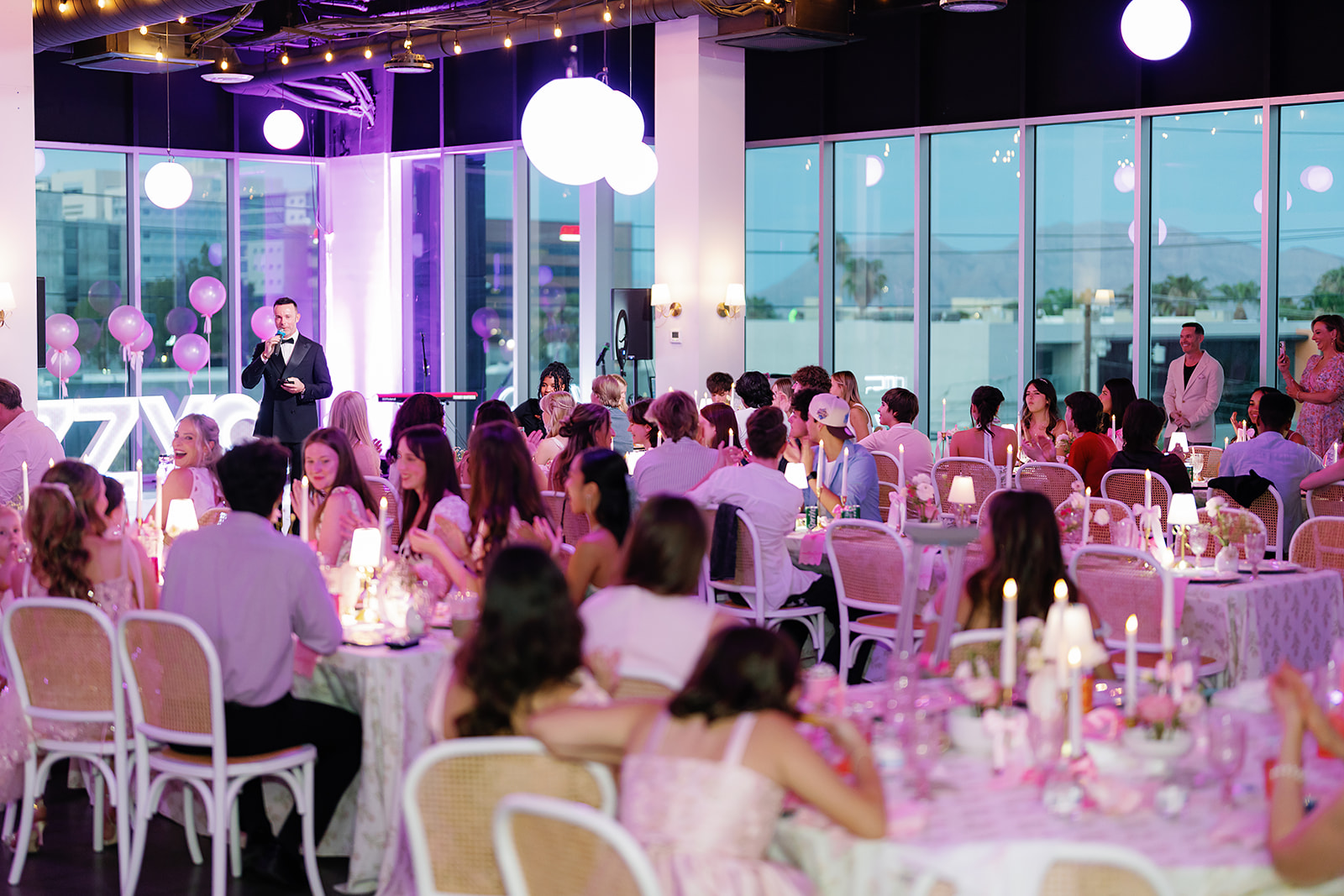 A seated reception in The View as the sun sets over the skyline